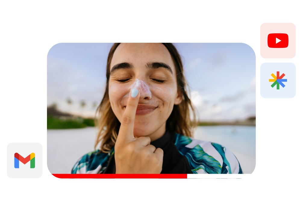 Gmail ad of a young woman outdoors applying sunscreen to her nose while making a silly face.